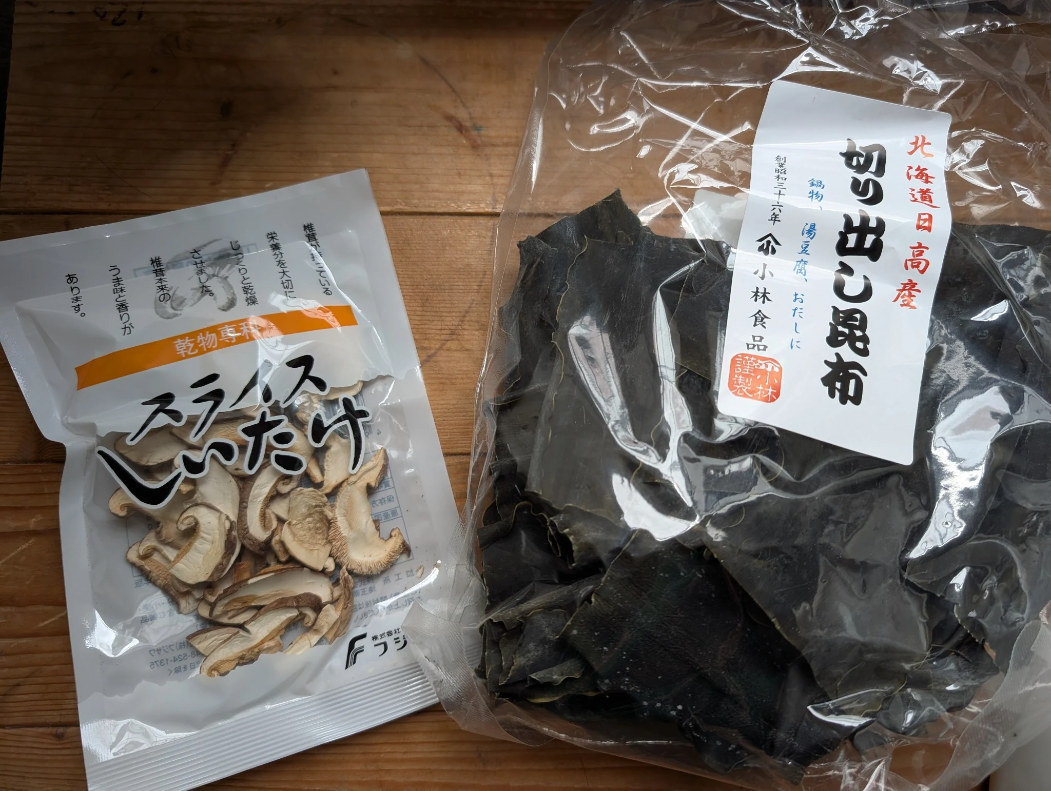 Bag of Japanese kiridashi kombu beside packaged sliced dried shiitake mushrooms
